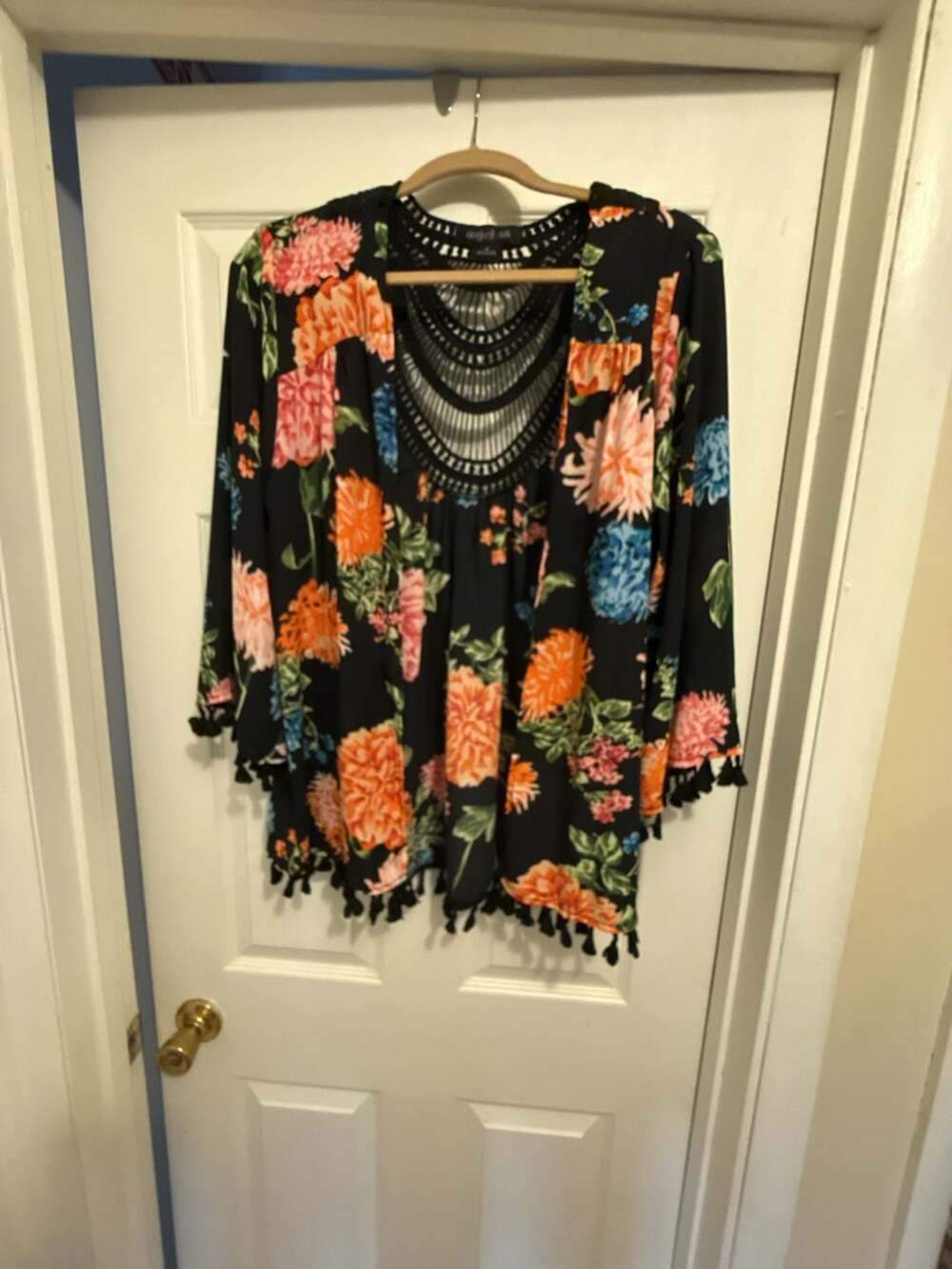 August Silk Black Floral Tassel Hem Crochet Neck Tunic Top